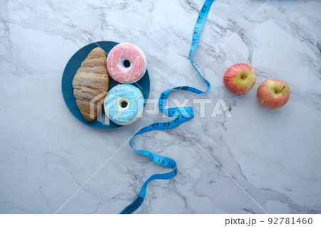 comparing donuts and apple, healthy diet concept comparing donuts and apple, healthy diet concept 92781460