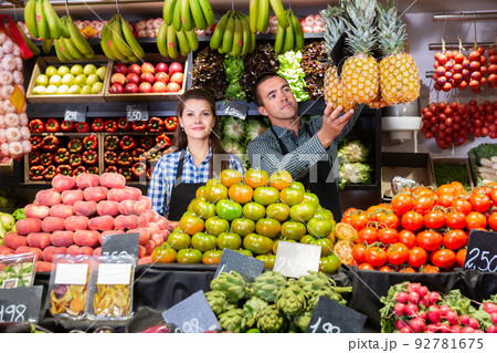 Two sellers laying out vegetables Two sellers laying out vegetables 92781675
