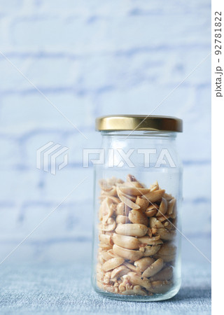 peanuts in a glass jar on table peanuts in a glass jar on table 92781822