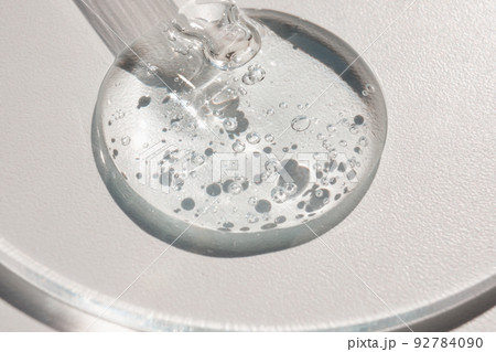 Pipette with sample of gels cosmetic product in petri dish on white background, hard shadows Pipette with sample of gels cosmetic product in petri dish on white background, hard shadows 92784090