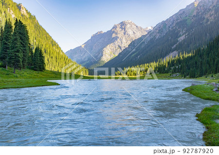 Idyllic summer landscape with hiking trail in the mountains with river with reflection and forest. Idyllic summer landscape with hiking trail in the mountains with river with reflection and forest. 92787920