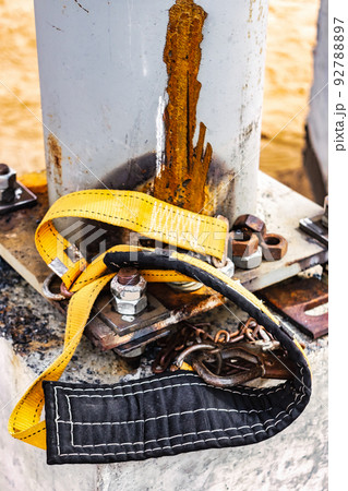 The safety belt of a welder or assembler lies on a concrete foundation at a construction site. Protection of a person working at height. Safety engineering. 92788897