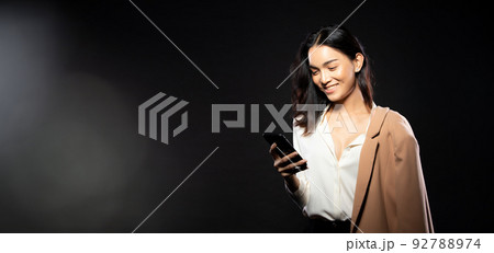 Half body portrait of Asian beautiful woman wear white shirt, using internet smart phone 92788974