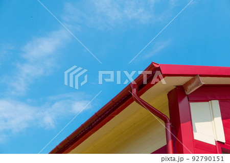Red gutter on the roof top of house. Red gutter on the roof top of house. 92790151
