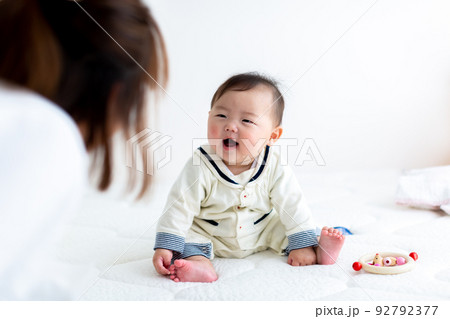 お座りをするあかちゃんと母親　乳児 92792377