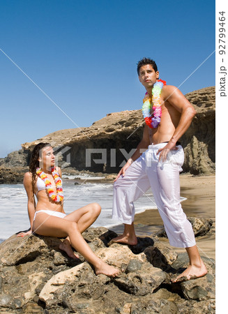Couple in love on the edge of the sea enjoying the sun Couple in love on the edge of the sea enjoying the sun 92799464