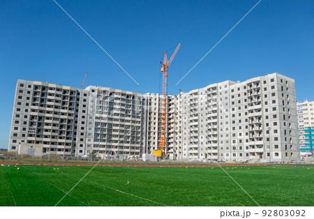 Construction machinery and multistorey houses under construction Construction machinery and multistorey houses under construction 92803092