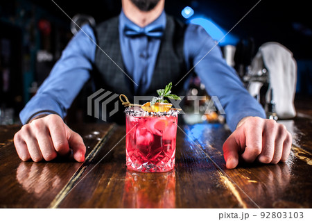 Bartender mixes a cocktail at the beerhouse Bartender mixes a cocktail at the beerhouse 92803103