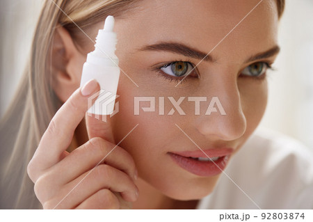Vision And Ophthalmology Medicine. Beautiful Woman Applying Eyedrops Vision And Ophthalmology Medicine. Beautiful Woman Applying Eyedrops 92803874