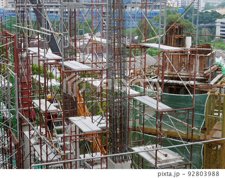 SELANGOR, MALAYSIA -JULY 4, 2021: Scaffolding is installed as temporary support for concrete formwork at the construction site. Installed according to the design approved by the engineer. SELANGOR, MALAYSIA -JULY 4, 2021: Scaffolding is installed as temporary support for concrete formwork at the construction site. Installed according to the design approved by the engineer. 92803988