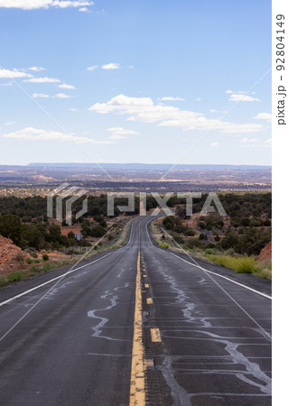 Scenic Road in the Dry Desert with Red Rocky Mountains in Background. 92804149