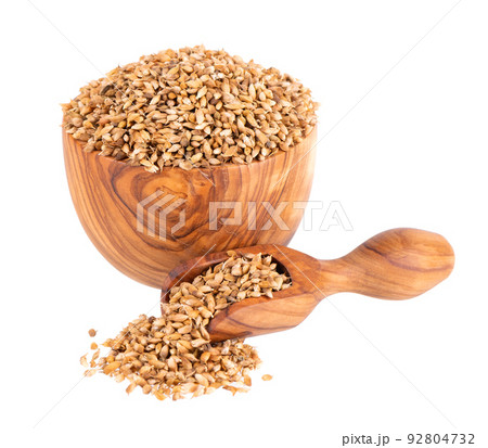 Utsho suneli seeds in wooden bowl and spoon, isolated on white background. Trigonella caerulea or blue fenugreek. Utsho suneli seeds in wooden bowl and spoon, isolated on white background. Trigonella caerulea or blue fenugreek. 92804732