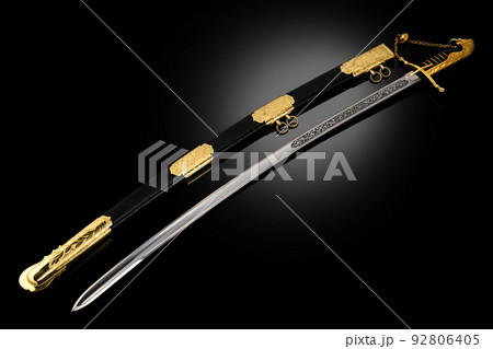 souvenir collectible silver gold dagger cutlass with scabbard, with metal engraving, on black background. Luxury weapons with traditional patterns in medieval vintage style. souvenir collectible silver gold dagger cutlass with scabbard, with metal engraving, on black background. Luxury weapons with traditional patterns in medieval vintage style. 92806405