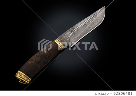 souvenir collectible silver gold dagger cutlass with scabbard, with metal engraving, on black background. Luxury weapons with traditional patterns in medieval vintage style. souvenir collectible silver gold dagger cutlass with scabbard, with metal engraving, on black background. Luxury weapons with traditional patterns in medieval vintage style. 92806481