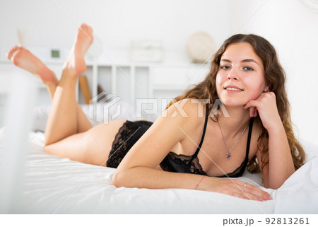 Sexy woman with long hair in underwear lying on bed Sexy woman with long hair in underwear lying on bed 92813261