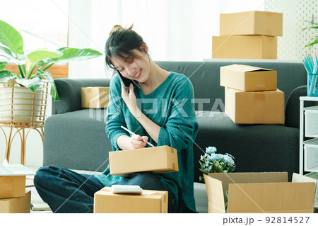 Asian business owner always keep contact with customer. 92814527