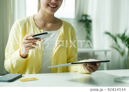 Asian woman using laptop and credit card for online shopping. Asian woman using laptop and credit card for online shopping. 92814534