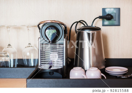 Espresso coffee capsules maker and cup on table 92815588