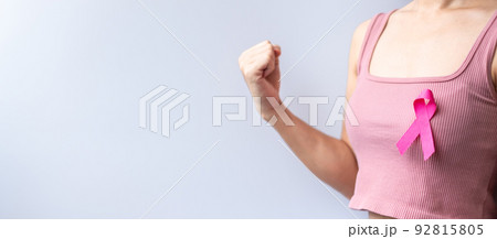 Pink October Breast Cancer Awareness month, woman hand hold pink Ribbon and wear shirt for support people life and illness. National cancer survivors month, Mother and World cancer day concept Pink October Breast Cancer Awareness month, woman hand hold pink Ribbon and wear shirt for support people life and illness. National cancer survivors month, Mother and World cancer day concept 92815805