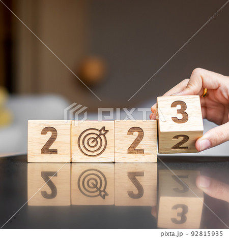 hand flip 2022 to 2023 block with dartboard sign. Business Goal, Target, Resolution, strategy, plan, Action motivation, change, thinking, countdown and New Year start concepts 92815935