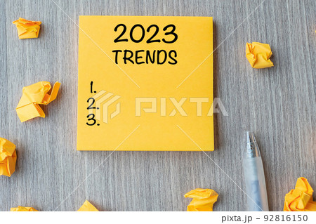 2023 Trends word on yellow note with pen and crumbled paper on wooden table background. New Year New Start, Resolutions, Strategy and Goal concept 2023 Trends word on yellow note with pen and crumbled paper on wooden table background. New Year New Start, Resolutions, Strategy and Goal concept 92816150