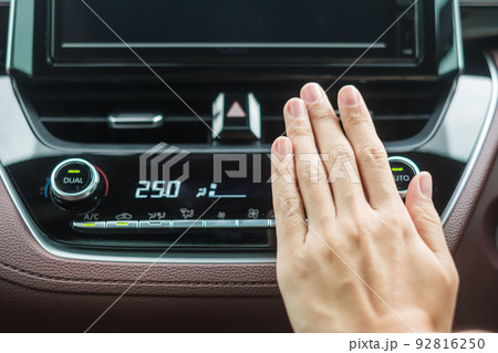 Woman hand checking the air flowing during driving car on the road, air conditioner cooling system inside the car. Adjust, temperature and transport concept 92816250