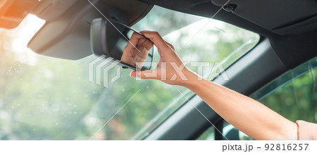 woman driver adjusting rear view mirror a car. Journey, trip and safety Transportation concepts woman driver adjusting rear view mirror a car. Journey, trip and safety Transportation concepts 92816257