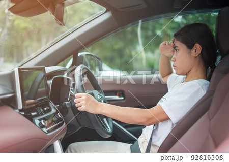 woman feeling stress and angry during drive car long time. Asian girl tired and fatigue having headache stop after driving car in traffic jam. Sleepy, stretching and drunk concept woman feeling stress and angry during drive car long time. Asian girl tired and fatigue having headache stop after driving car in traffic jam. Sleepy, stretching and drunk concept 92816308