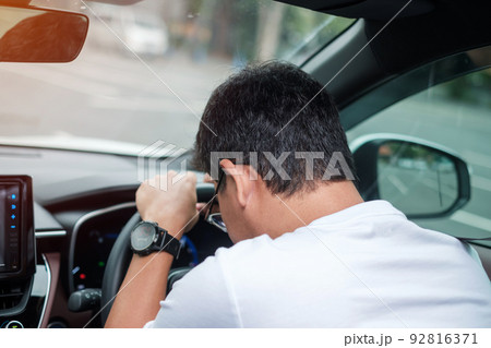 man feeling stress and angry during drive car long time. Asian male tired and fatigue having headache stop after driving car in traffic jam. Sleepy, stretching and drunk concept 92816371