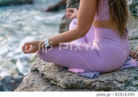Young woman practicing yoga outdoors. Harmony and meditation concept. Healthy lifestyle Young woman practicing yoga outdoors. Harmony and meditation concept. Healthy lifestyle 92816390