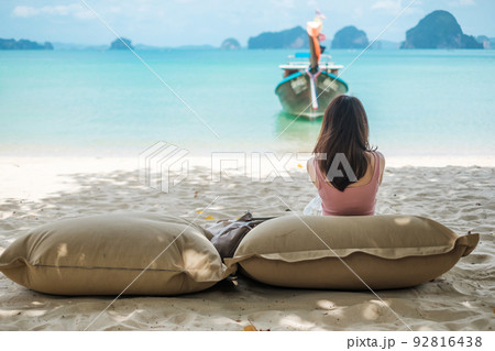 Woman tourist rest on Beautiful beach Island at summer. destination, wanderlust, Asia Travel, tropical summer, vacation and holiday concept Woman tourist rest on Beautiful beach Island at summer. destination, wanderlust, Asia Travel, tropical summer, vacation and holiday concept 92816438
