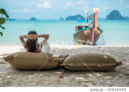 Woman tourist rest on Beautiful beach Island at summer. destination, wanderlust, Asia Travel, tropical summer, vacation and holiday concept Woman tourist rest on Beautiful beach Island at summer. destination, wanderlust, Asia Travel, tropical summer, vacation and holiday concept 92816439