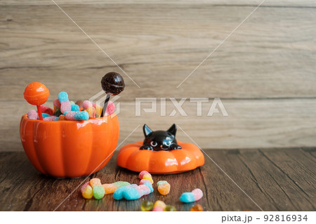 Happy Halloween day with ghost candies, pumpkin bowl, Jack O lantern and decorative (selective focus). Trick or Threat, Hello October, fall autumn, Festive, party and holiday concept 92816934