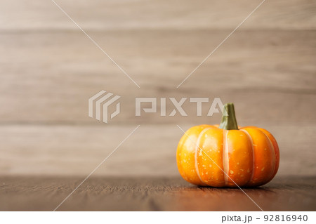 Orange pumpkin on table with copy space for banner background. Happy Halloween day, Hello October, fall autumn season, Festive, party and holiday concept Orange pumpkin on table with copy space for banner background. Happy Halloween day, Hello October, fall autumn season, Festive, party and holiday concept 92816940