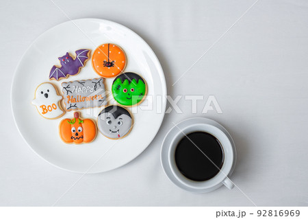 hot coffee cup with funny Halloween Cookies. Happy Halloween day, Trick or Threat, Hello October, fall autumn, Traditional, party and holiday concept hot coffee cup with funny Halloween Cookies. Happy Halloween day, Trick or Threat, Hello October, fall autumn, Traditional, party and holiday concept 92816969