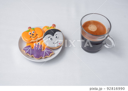hot espresso coffee or chocolate cup with funny Halloween Cookies. Happy Halloween day, Trick or Threat, Hello October, fall autumn, Traditional, party and holiday concept hot espresso coffee or chocolate cup with funny Halloween Cookies. Happy Halloween day, Trick or Threat, Hello October, fall autumn, Traditional, party and holiday concept 92816990