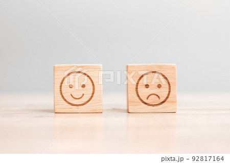 emotion face symbol on wooden blocks. Service rating, ranking, customer review, satisfaction, evaluation and feedback concept 92817164