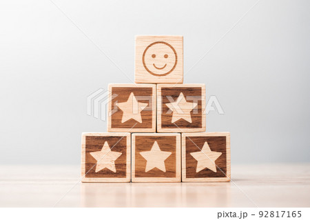 emotion face and Star symbol blocks on table background. Service rating, ranking, customer review, satisfaction, evaluation and feedback concept 92817165