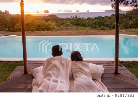 Happy Couple traveler enjoy Beautiful ocean view, Tourists relaxing in tropical luxury resort with swimming pool.Together, honeymoon, love, travel and summer vacation concept 92817332