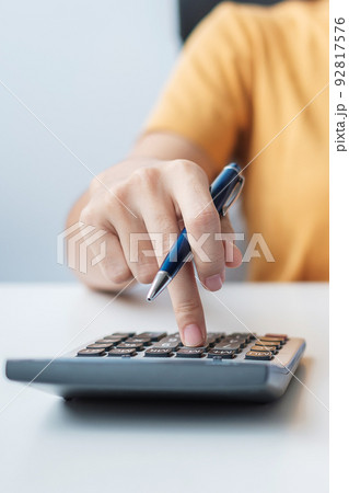 Woman using calculator. Contract agreement, rental finance and accounting concepts Woman using calculator. Contract agreement, rental finance and accounting concepts 92817576