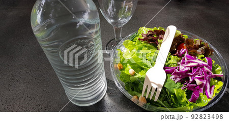 Healthy vegetable salad of fresh tomato, lettuce and red cabbage with wooden spoon and caesar salad dressing Diet menu Top view Healthy vegetable salad of fresh tomato, lettuce and red cabbage with wooden spoon and caesar salad dressing Diet menu Top view 92823498
