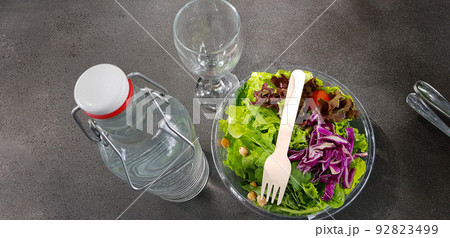 Healthy vegetable salad of fresh tomato, lettuce and red cabbage with wooden spoon and caesar salad dressing Diet menu Top view Healthy vegetable salad of fresh tomato, lettuce and red cabbage with wooden spoon and caesar salad dressing Diet menu Top view 92823499