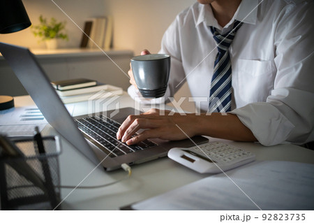 Asian businessman working on laptop in night office. dark late night at home office online meeting work hard concept. 92823735