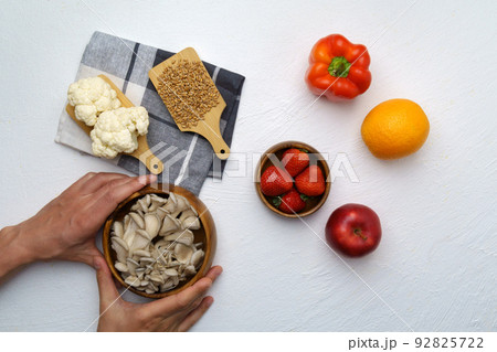 Organic food background of various fruits and vegetables, vegan food ingredients. Mushrooms, orange, strawberry, pepper Organic food background of various fruits and vegetables, vegan food ingredients. Mushrooms, orange, strawberry, pepper 92825722