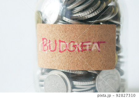 budget text on a saving coins jar on white budget text on a saving coins jar on white 92827310