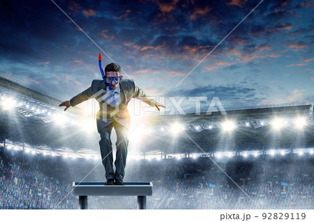 Young businessman in suit ready to dive Young businessman in suit ready to dive 92829119