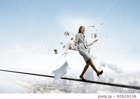 Young pretty businesswoman juggling with business items 92829136