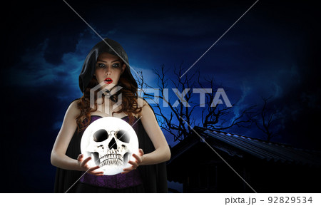Beautiful young woman in witches hat and costume Beautiful young woman in witches hat and costume 92829534
