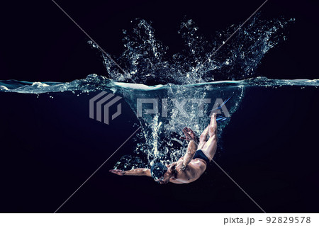 Professional man swimmer on a wave Professional man swimmer on a wave 92829578