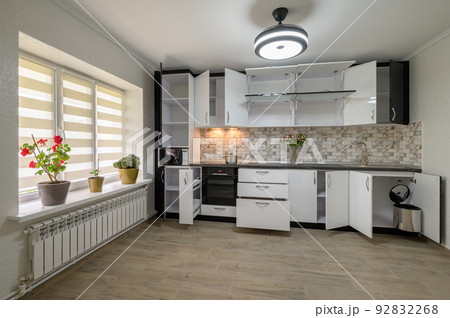 Renovated Interior for modern trendy white kitchen with doors open Renovated Interior for modern trendy white kitchen with doors open 92832268